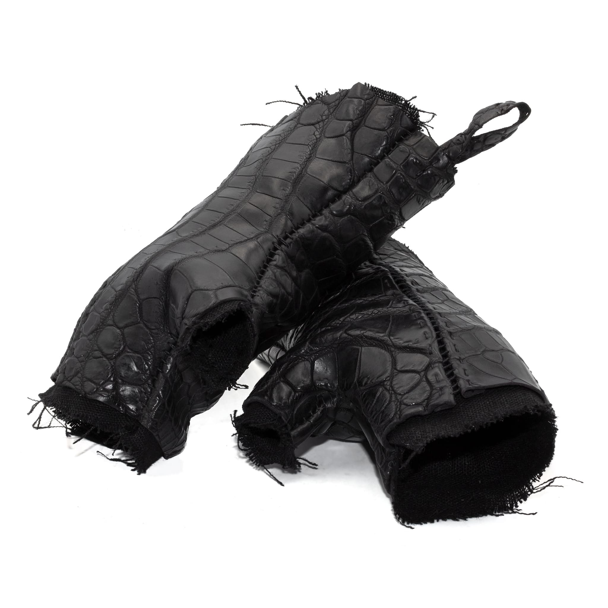hand stitched over a 40hr period the genuine crocodile leather gloves feature deconstructed open seam panels, and a raw cut vintage french linen lining. with an object dyed finish the gloves are then wet moulded on the body over an 8 hour period for a sculptured aesthetic. the gloves are available to buy online from avant garde leather studio atelierskn.com