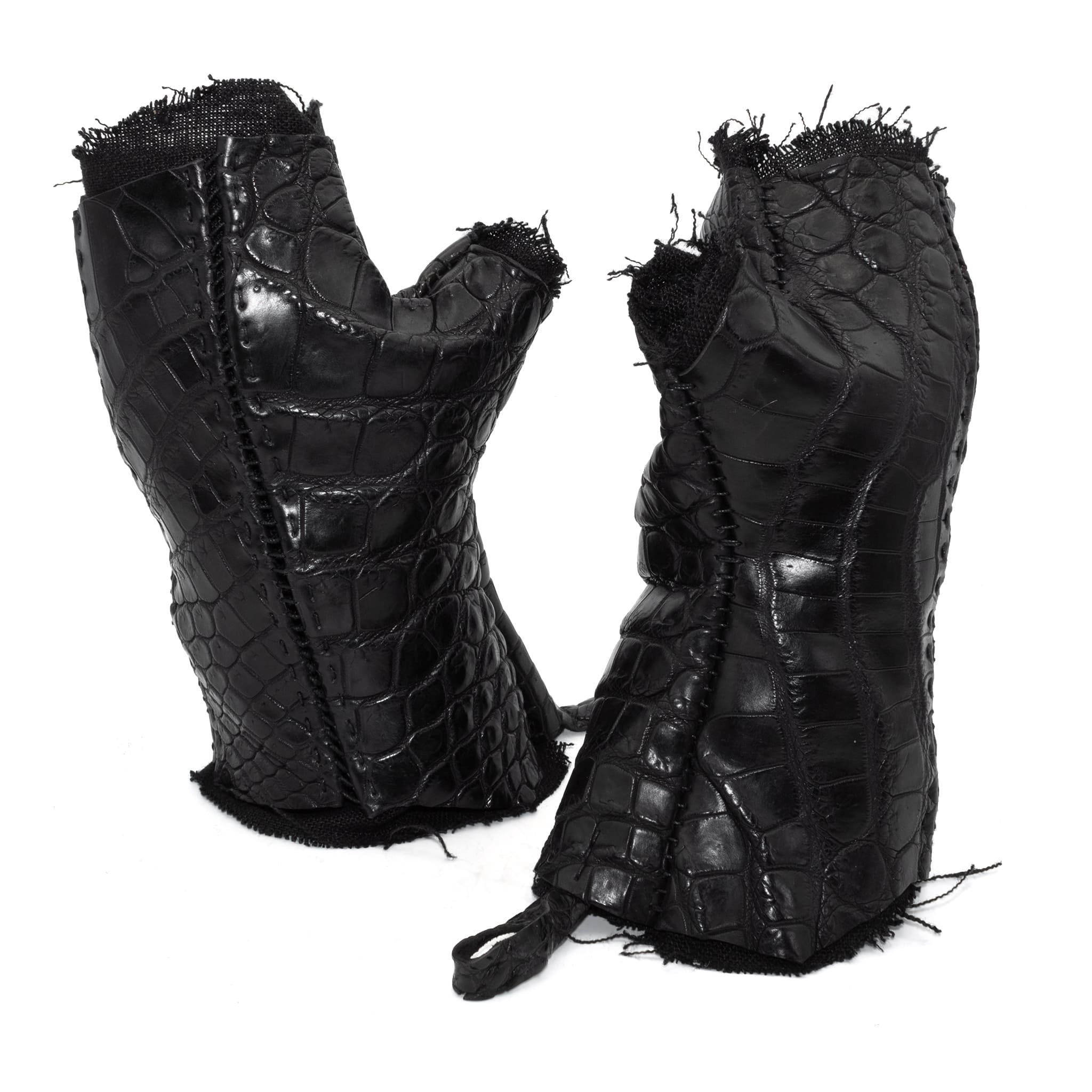 hand stitched over a 40hr period the genuine crocodile leather gloves feature deconstructed open seam panels, and a raw cut vintage french linen lining. with an object dyed finish the gloves are then wet moulded on the body over an 8 hour period for a sculptured aesthetic. the gloves are available to buy online from avant garde leather studio atelierskn.com