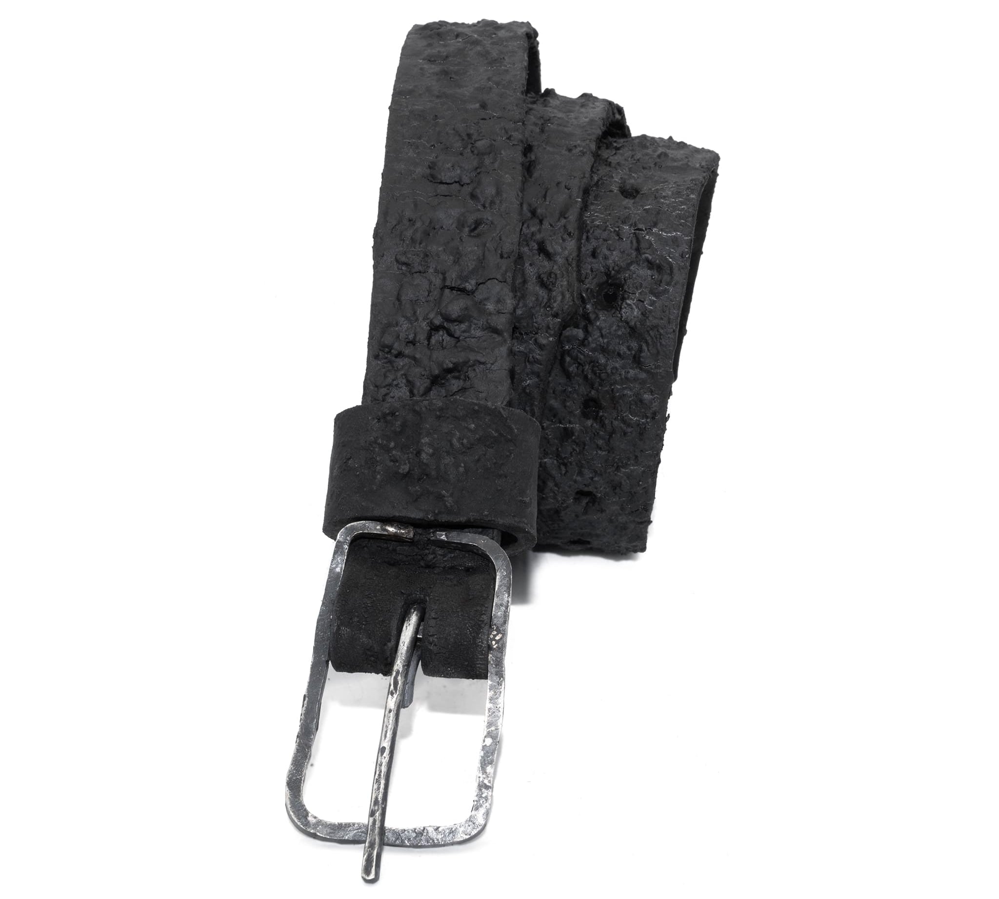 the pyroclastic belt features multiple layers of volcanic ash, sterling silver, burnt bronze layered over 28 days on top of an object dyed matte black full grain reverse horse culatta leather belt. with a hand forged oxidised .925 sterling silver buckle for men and women. expertly hand sewn by independent UK based artisanal designer atelier SKN.