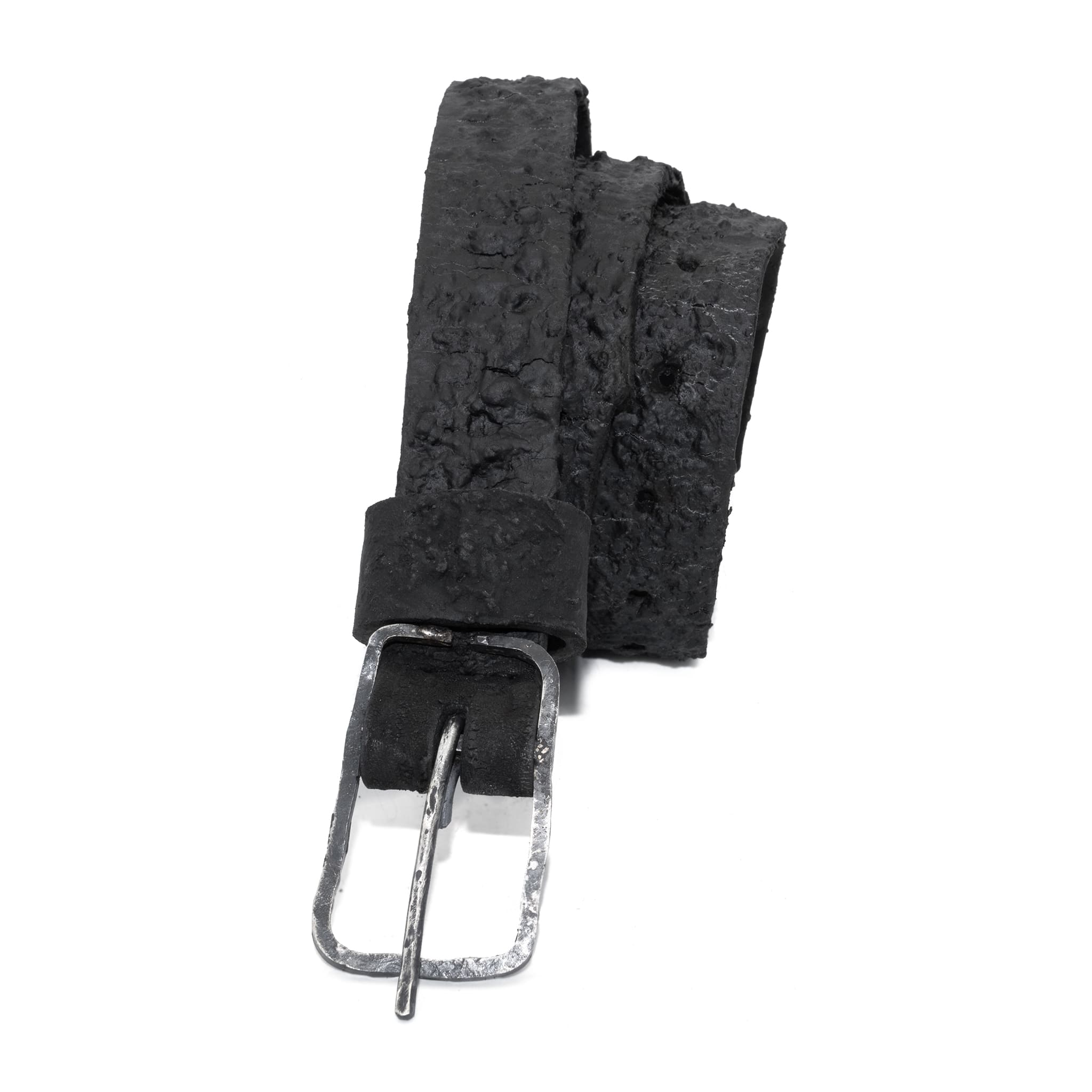 the pyroclastic belt features multiple layers of volcanic ash, sterling silver, burnt bronze layered over 28 days on top of an object dyed matte black full grain reverse horse culatta leather belt. with a hand forged oxidised .925 sterling silver buckle for men and women. expertly hand sewn by independent UK based artisanal designer atelier SKN.