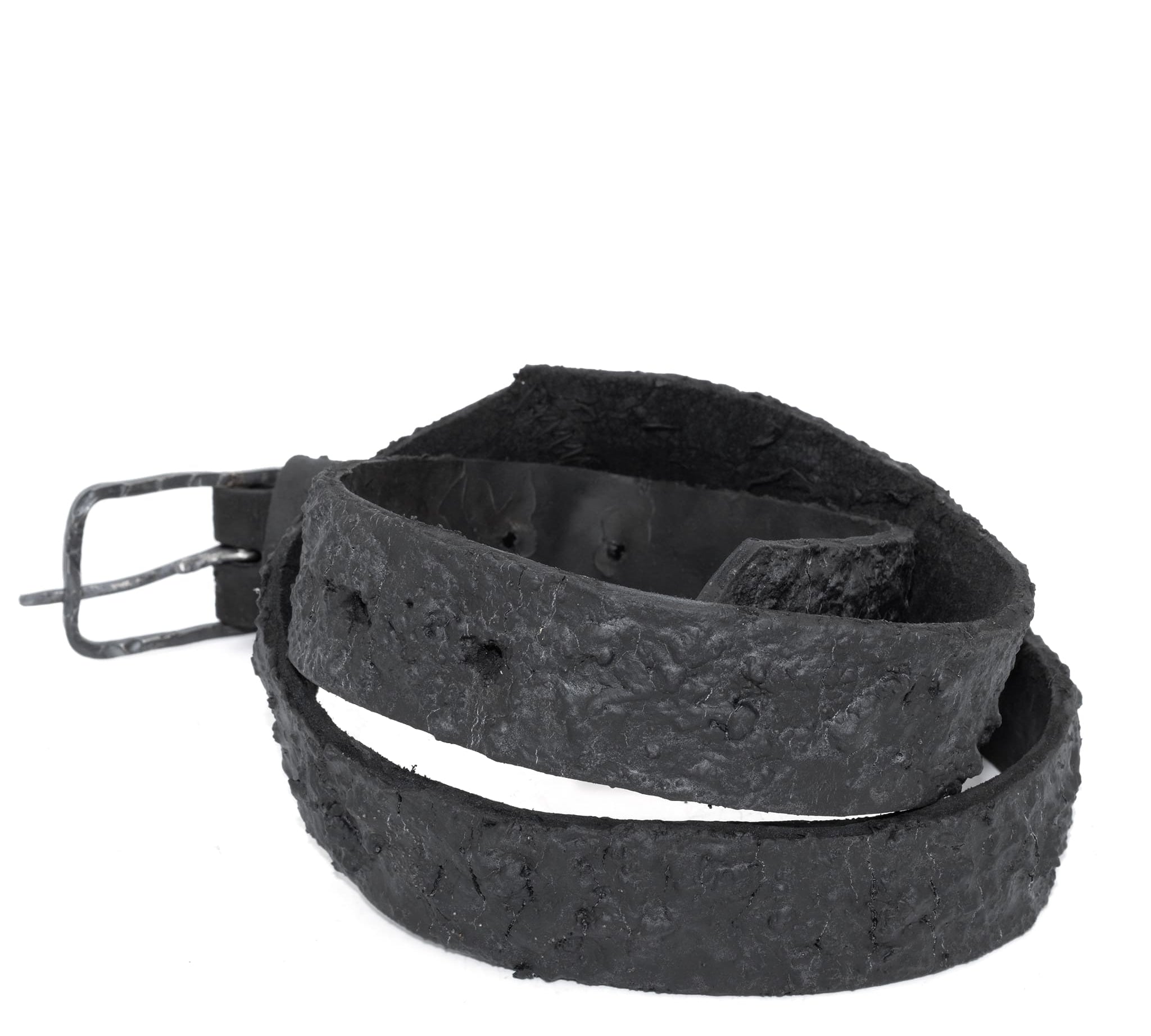 the pyroclastic belt features multiple layers of volcanic ash, sterling silver, burnt bronze layered over 28 days on top of an object dyed matte black full grain reverse horse culatta leather belt. with a hand forged oxidised .925 sterling silver buckle for men and women. expertly hand sewn by independent UK based artisanal designer atelier SKN.