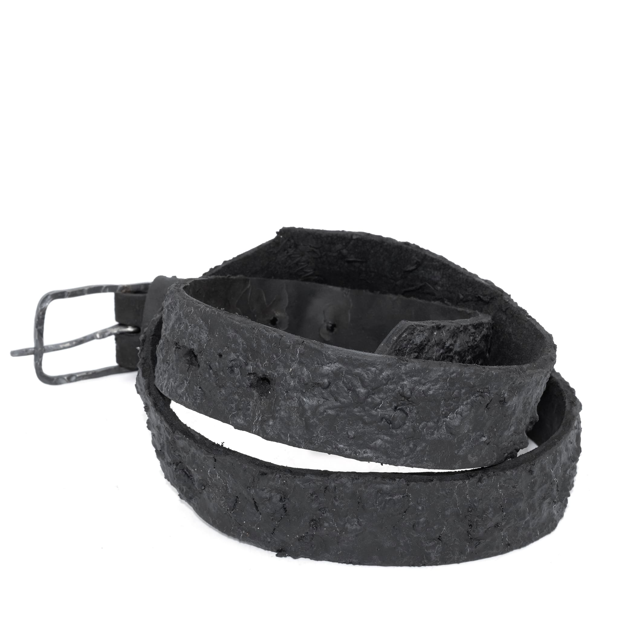 the pyroclastic belt features multiple layers of volcanic ash, sterling silver, burnt bronze layered over 28 days on top of an object dyed matte black full grain reverse horse culatta leather belt. with a hand forged oxidised .925 sterling silver buckle for men and women. expertly hand sewn by independent UK based artisanal designer atelier SKN.