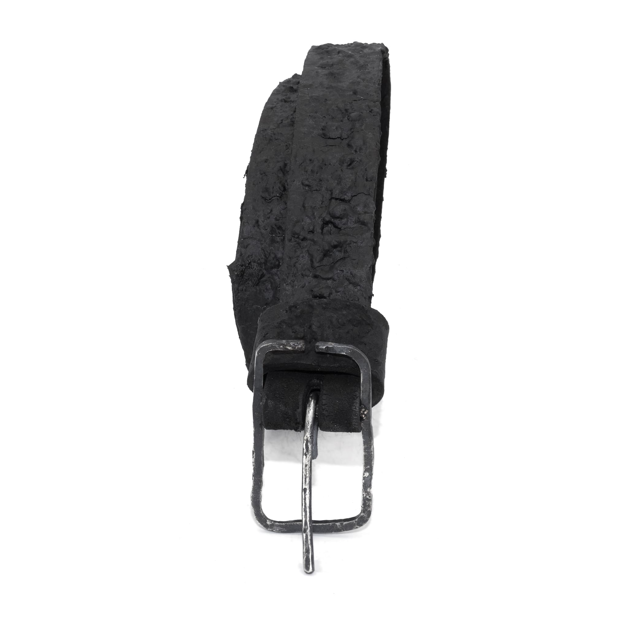 the pyroclastic belt features multiple layers of volcanic ash, sterling silver, burnt bronze layered over 28 days on top of an object dyed matte black full grain reverse horse culatta leather belt. with a hand forged oxidised .925 sterling silver buckle for men and women. expertly hand sewn by independent UK based artisanal designer atelier SKN.