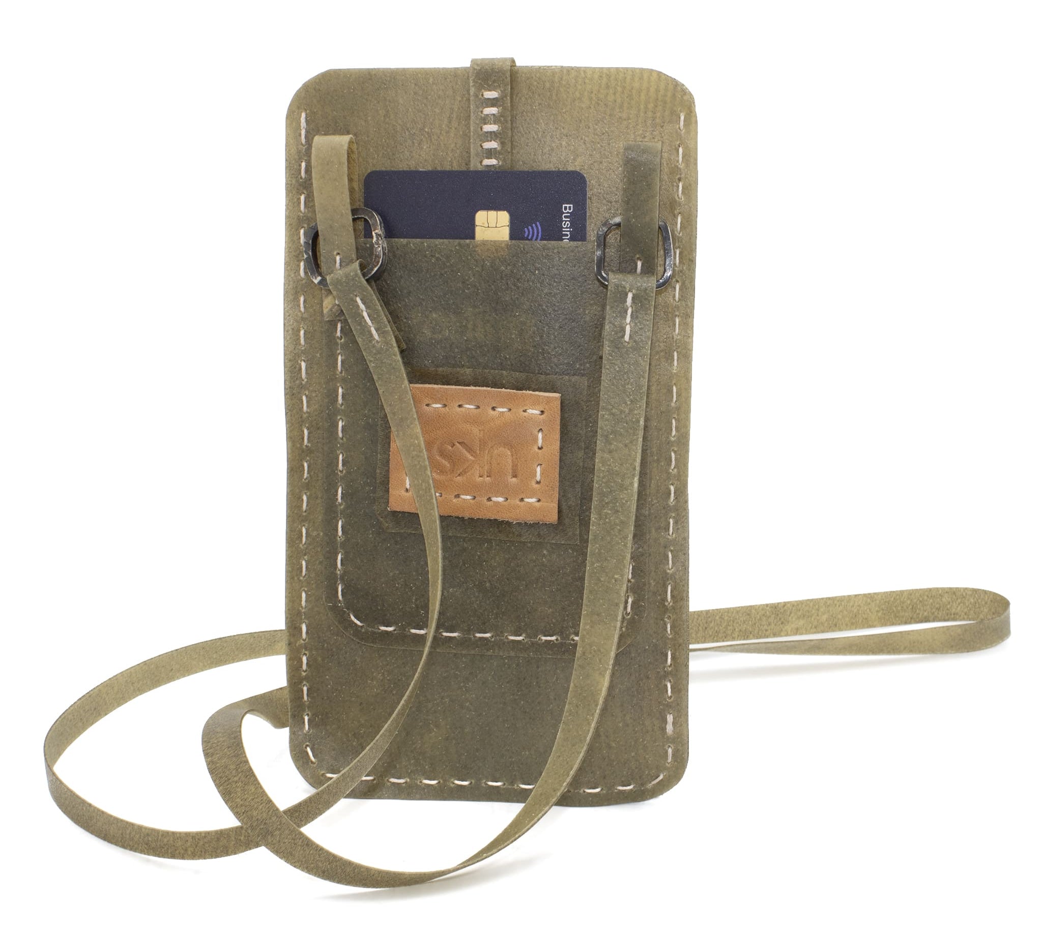 meticulously hand stitched, the transparent horse leather phone case features a minimal silhouette with tonal linen stitching and hand forged .925 sterling silver hardware. the phone holder is available to buy online from avant garde designer atelierskn.com 