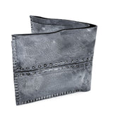 a closed seam 6 pocket bifold wallet crafted from a supple matte black kangaroo leather with a contrasting pigmented wax finish available to buy online from artisanal leather studio atelierskn.com