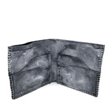 a closed seam 6 pocket bifold wallet crafted from a supple matte black kangaroo leather with a contrasting pigmented wax finish available to buy online from artisanal leather studio atelierskn.com