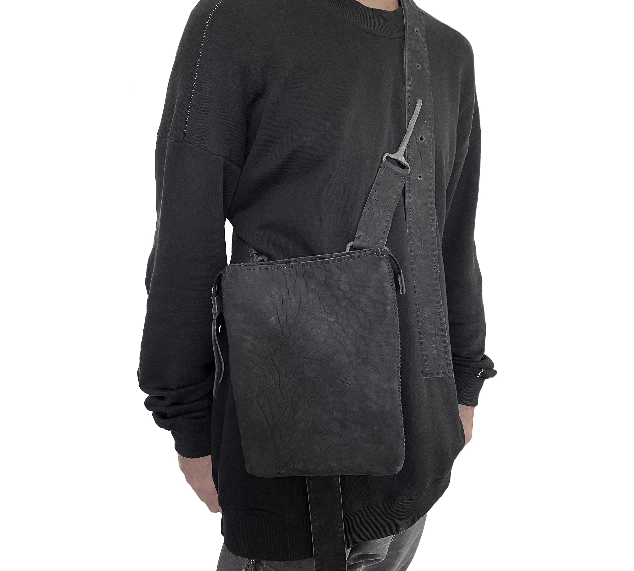 hand sewn avant garde black leather shoulder bag from atelier skn.